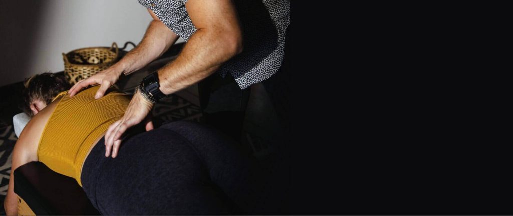 Dr. Tony Miller performing a chiropractic adjustment on a patient, focusing on spinal health and long-lasting healing.
