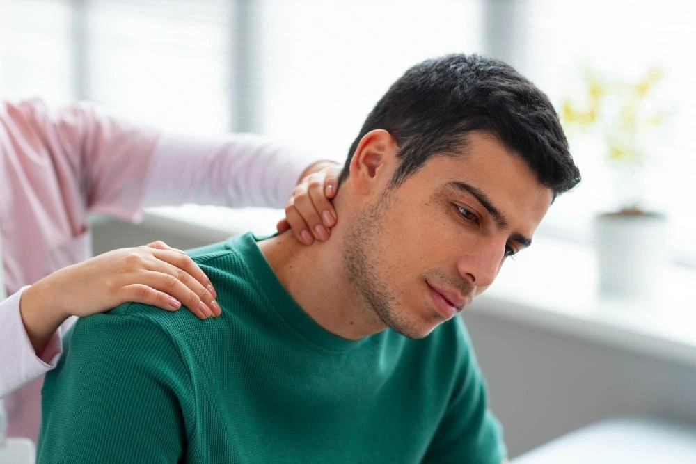 Chiropractor helping patient with neck pain