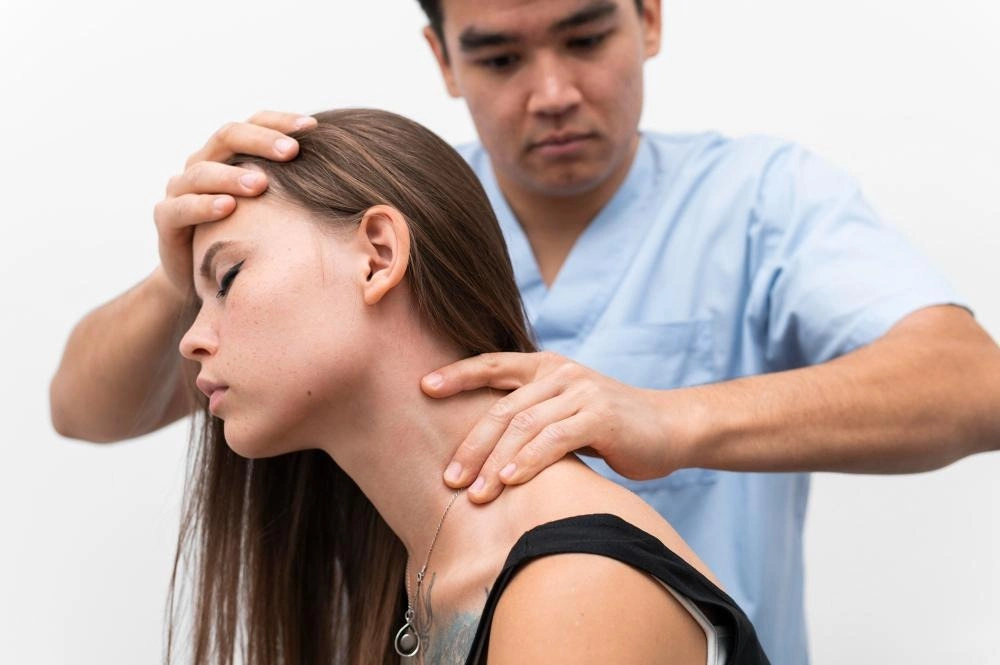 Chiropractor palpating neck after woman whiplash injury occured