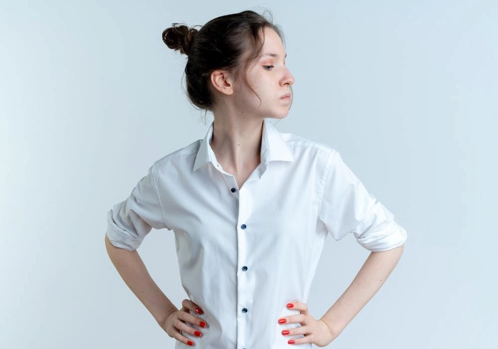 Young confident girl puts hands on waist looking at side