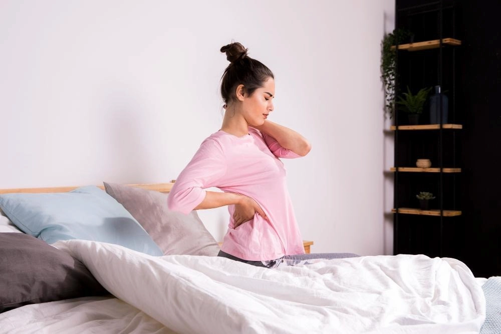 Woman waking up in the morning back pain