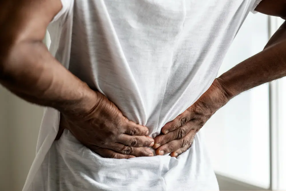 Person experiencing chronic back pain from degenerative disc disease