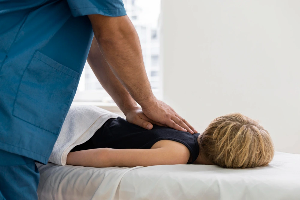 Chiropractor providing gentle care to child patient