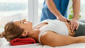 Doctor examining postpartum abdominal area during recovery and wellness assessment