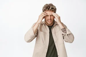 Person experiencing dizziness while standing and trying to maintain balance