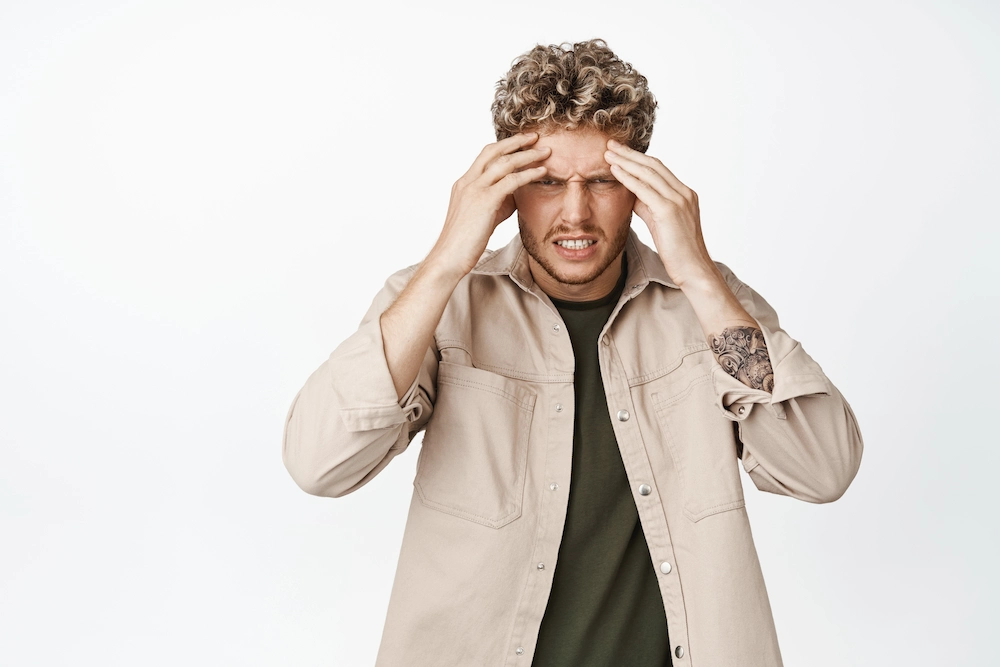 Person experiencing dizziness while standing and trying to maintain balance