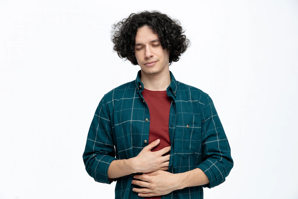 Person holding stomach while focusing on overall health and wellness
